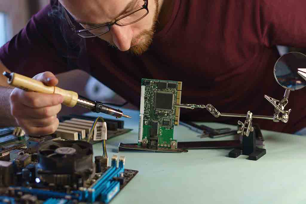 guy inspecting computer hardware